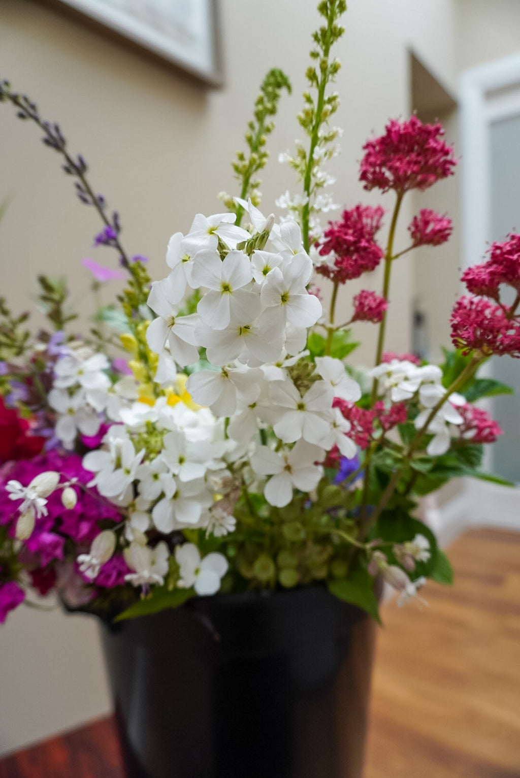 Flower bucket assortment containing flowers and foliage grown in Naas
