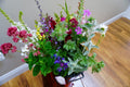 Flower bucket assortment containing flowers and foliage grown in Naas