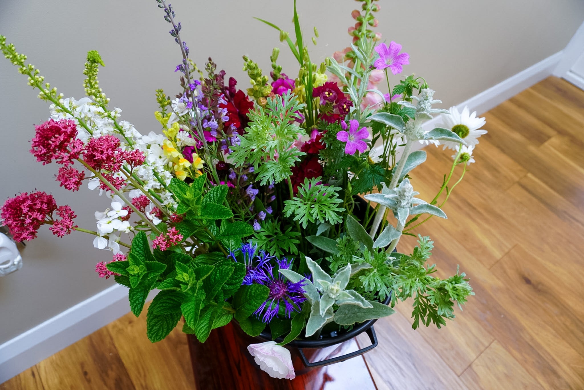 Flower bucket assortment containing flowers and foliage grown in Naas